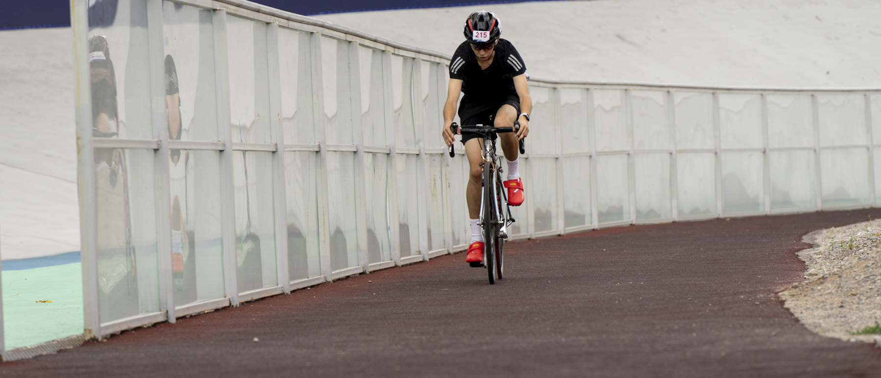Daniyar Kalikulov riding a road bike on a velodrome
